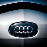 : The iconic Audi logo featuring four interlocked rings symbolizing unity and history.